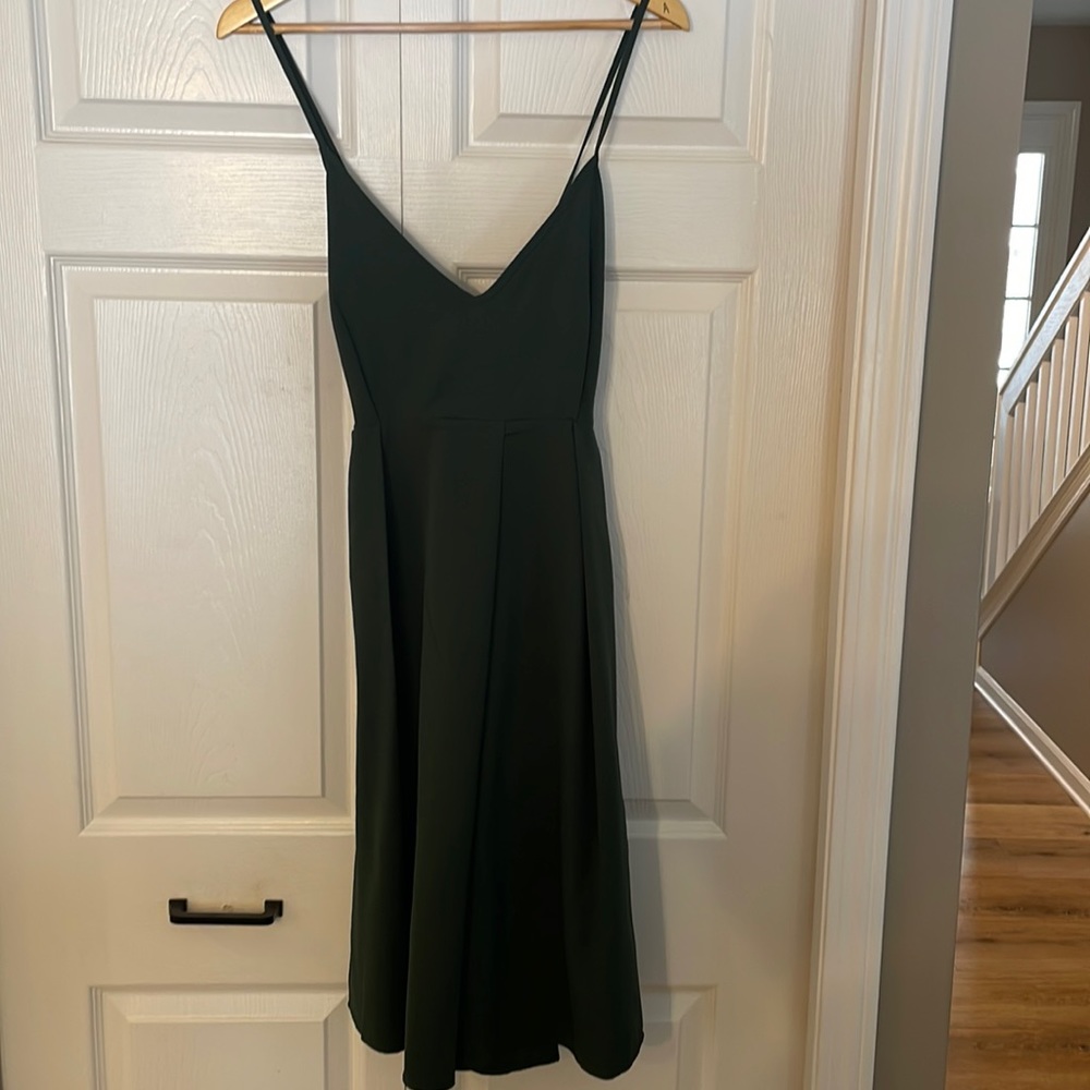 Green dress. Perfect for wedding guest. Has pockets! Criss cross back detail